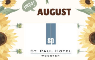 Decorative August banner with yellow sunflowers framing a centered St. Paul Hotel Wooster logo and a small 'Hello!' speech bubble.